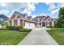 Charming two-story home boasts a manicured lawn and a spacious three-car garage, blending comfort and curb appeal at 11626 Laurel Springs Cir, Noblesville, IN 46060