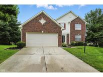 Charming two-story home features a brick facade, attached garage, and well-maintained lawn at 13264 Penneagle Dr, Carmel, IN 46033