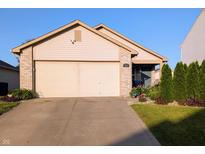 Charming single-story home with a well-maintained lawn and an attached two-car garage at 1823 Long Lake Dr, Greenwood, IN 46143