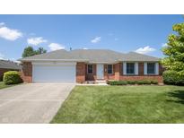 Charming single-story brick home featuring a well-manicured lawn and an attached two-car garage at 370 Vinewood S Dr, Brownsburg, IN 46112