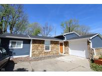 Charming single-story home with stone accents, blue siding, and an attached one car garage at 3836 N Wittfield St, Indianapolis, IN 46235