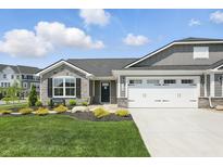 Charming single-story home featuring stone accents, gray siding, a well-manicured lawn, and a two-car garage at 4182 Hume Ave, Plainfield, IN 46168