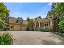 Charming home with a stone and siding exterior, manicured lawn, and a spacious driveway leading to a two-car garage at 5720 Hickory Hollow Dr, Plainfield, IN 46168