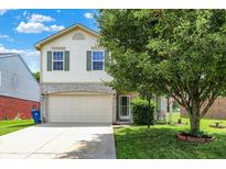 Charming two-story home featuring a two-car garage and well-maintained front yard with mature trees at 5841 Sable Dr, Indianapolis, IN 46221