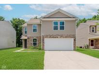Two-story home with a two car garage, brick accents, well-kept lawn, and neutral colored siding at 8248 Ossian Ct, Camby, IN 46113