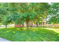 Charming home featuring a well-manicured lawn and mature trees that provide ample shade at 8557 Vyners Ln, Avon, IN 46123