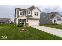 Beautiful two-story home boasts a well-manicured lawn, neutral siding, and an attached two-car garage at 9309 Kellner St, Pendleton, IN 46064