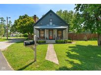 Charming home featuring stone accents, a covered porch, and a well-manicured lawn with a mailbox at 11315 House St, Indianapolis, IN 46259