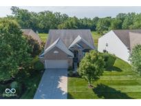 Charming brick home with a well-manicured lawn and mature trees in a peaceful residential neighborhood at 13161 Duval Dr, Fishers, IN 46037
