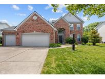 Charming brick two-story home with well-manicured lawn and two-car garage on a sunny day at 1319 Gable Lake Dr, Brownsburg, IN 46112