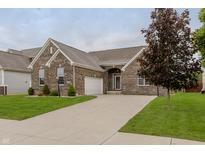 Charming single-story brick home with a well-manicured lawn and a paved driveway leading to an attached garage at 14332 Eddington Pl, Fishers, IN 46037