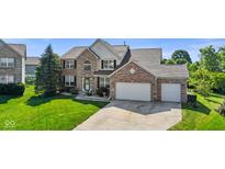 Charming two-story brick home with a well-manicured lawn and a spacious three-car garage at 2096 Whitetail Ct, Avon, IN 46123