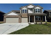 Charming two-story home featuring a brick facade, a spacious two-car garage, and a well-maintained lawn at 210 Ames Dr, Whiteland, IN 46184