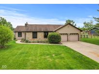 Charming ranch home with stone accents, attached two-car garage, and a well-manicured lawn at 2303 Alexandria Dr, Greenfield, IN 46140