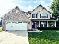 Charming two-story home featuring a brick and siding facade, well-manicured lawn, and a two-car garage at 2444 Cole Branch Ct, Indianapolis, IN 46239