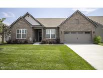 Charming single-story brick home featuring a well-manicured lawn and attached two-car garage at 5081 Holborn Ave, McCordsville, IN 46055