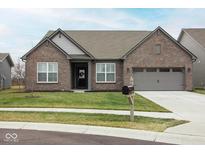Charming brick home featuring an attached two-car garage and manicured front lawn at 5081 Holborn Ave, McCordsville, IN 46055
