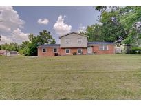 Well-maintained brick house with a large front yard and mature trees, creating a welcoming curb appeal at 5226 W Southport Rd, Indianapolis, IN 46221