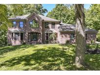 Beautiful brick home with a well manicured lawn and mature trees at 5826 Winding Way Ln, Indianapolis, IN 46220