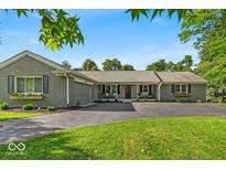 Charming ranch style home with brick and gray accents and a well-manicured lawn at 5850 E 54Th Pl, Indianapolis, IN 46226