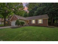 Charming brick home with a well-manicured lawn and mature trees in a serene, quiet neighborhood setting at 5935 Oakforge Ln, Indianapolis, IN 46254
