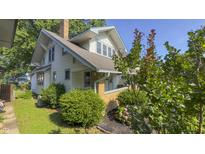 Charming two-story home features a classic design, well-maintained landscaping, and a welcoming front porch at 622 N Dequincy St, Indianapolis, IN 46201