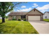 Charming single-story home with brick accents, well-manicured lawn, and attached two-car garage at 652 White Ash Trl, Mooresville, IN 46158