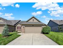 Charming single-story home with a two-car garage, complemented by lush greenery and a well-maintained lawn at 785 Cottage Ln, Greenwood, IN 46143