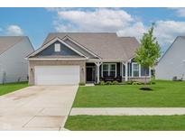 Charming home with a brick and siding facade, well-manicured lawn, and inviting front porch at 9806 Olympic Blvd, Pendleton, IN 46064