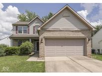 Charming two-story home with a brick facade and attached two-car garage at 1225 Berrywood Dr, Greenwood, IN 46143