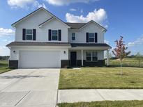 Charming two-story home showcasing a well-maintained lawn, a two-car garage, and a welcoming front porch at 1256 Little Rodeo Pl, Greenwood, IN 46143