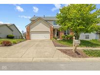 Charming two-story home with a well-manicured lawn, brick accents, and an attached two-car garage at 1260 Easton Point Dr, Greenwood, IN 46142