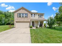 Charming two-story home with a brick and vinyl exterior, attached garage, front porch, and well-maintained lawn at 14754 Drayton Dr, Noblesville, IN 46062