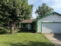 Charming single-story home featuring a well-manicured lawn and attached garage at 3309 Wedgewood Dr, Indianapolis, IN 46227