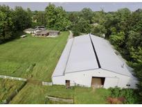 Spacious property featuring a large metal building, house, and meticulously maintained green spaces at 3942 Senour Rd, Indianapolis, IN 46239