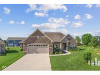 Beautiful single-Gathering home featuring a well-manicured lawn and brick exterior at 5220 Orahood Ct, Plainfield, IN 46168