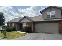 Charming brick home with an attached two-car garage and well-maintained landscaping at 6139 Robinwood Dr, Indianapolis, IN 46237