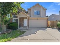 Charming two-story home featuring a front-facing garage, and a well-manicured front yard at 618 Stobus Dr, Greenwood, IN 46143