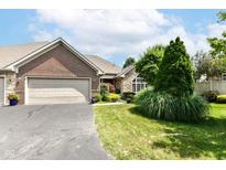 Charming brick home featuring a two-car garage and well-maintained landscaping at 6656 Easy St, Fishers, IN 46038