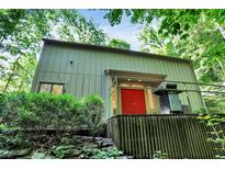 Stunning exterior view with a red door and beautiful landscaping, nestled in a lush setting at 944 Briar Patch Ln, Greenwood, IN 46142