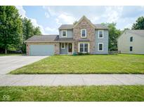 Charming two-story home with a well-maintained lawn and a blend of siding and brick facade at 10751 Sheffield Ct, Fishers, IN 46038