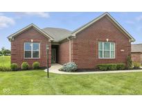 Charming brick home featuring well-manicured lawn and landscaped garden at 1127 Kay Dr, Greenwood, IN 46142