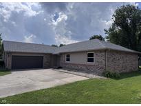Charming single-story brick home featuring an attached garage and well-maintained lawn at 1206 Brownswood Dr, Brownsburg, IN 46112