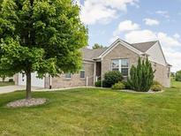 Charming brick home with lush green lawn, mature tree, and white trim at 13019 Pinner Ave, Fishers, IN 46037