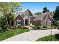 Charming brick home featuring a stone entryway and manicured landscaping at 14027 Waterway Blvd, Fishers, IN 46040