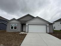 Charming one-story home featuring gray siding, a two-car garage, and a welcoming front entrance at 1436 Aster Dr, Shelbyville, IN 46176