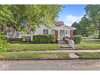 Charming home featuring a well-maintained lawn, inviting front porch, and classic architectural details at 2020 N B St, Elwood, IN 46036