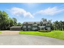 Two-story home with lush green lawn and convenient three-car garage at 2227 Hidden Orchard Ct, Indianapolis, IN 46228