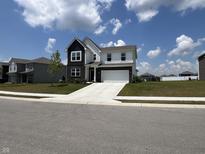Charming two-story home featuring a classic white exterior, black accents, attached garage, and inviting curb appeal at 2232 Warbler St, Danville, IN 46122
