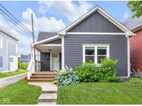 Charming home with a well-maintained lawn and a welcoming front porch at 329 Parkway Ave, Indianapolis, IN 46225